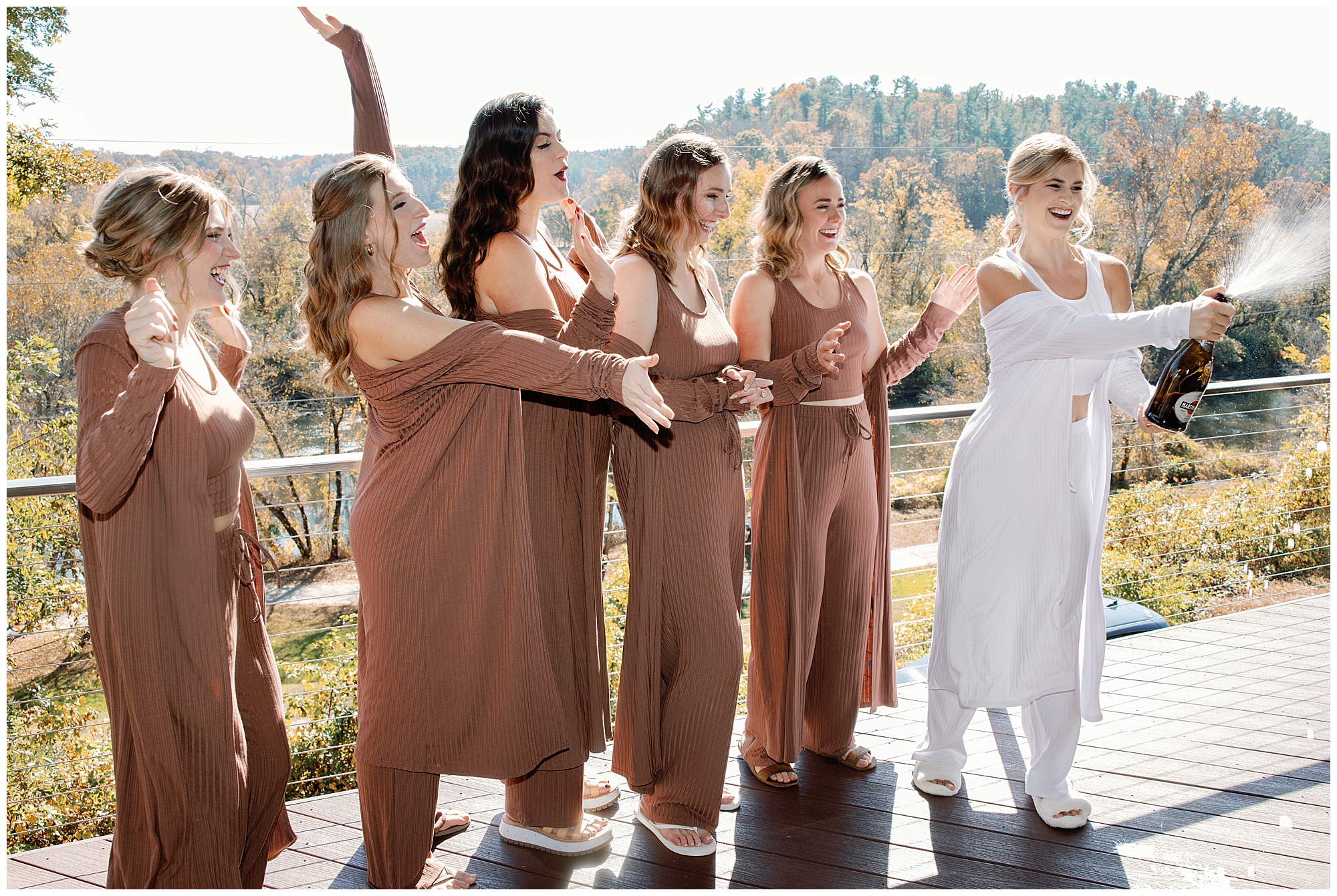 bridemaids pop champagne bottle at airbnb before wedding Katherine Denise Films Asheville Weddingg